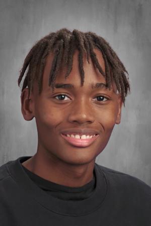 This photo shows a headshot of Jason Dale, a student at Muchin College Prep. He is a young Black man with short locs. In this photo, he is smiling and wearing a black sweatshirt.